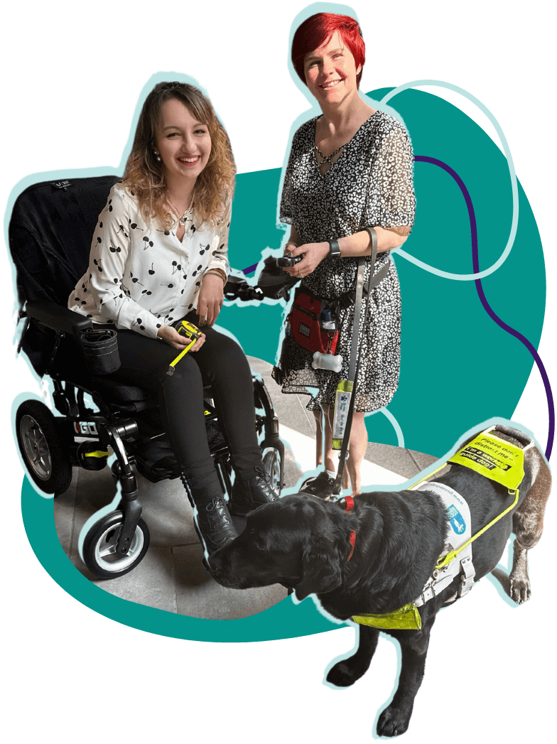 Patchwork Hub team smiling together during an accessibility assessment, one is in her powerchair and the other with her guide dog. 